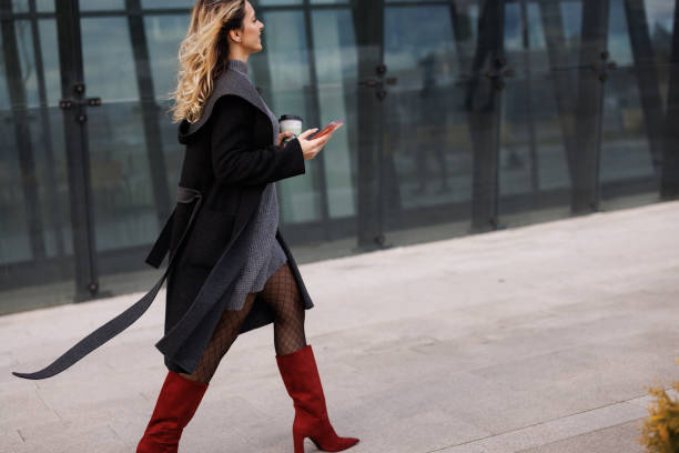 istock Businesswoman Texting on her Smartphone on the Go 1365140156