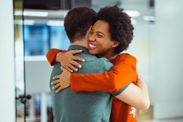 istock Laughing african-american, giving a supportive hug to her employee. 1365141188