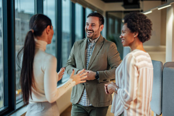 istock Cheerful male manager, motivating his team to work by making them laugh. 1365141189