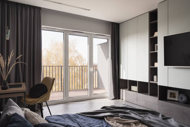 istock Bright bedroom with window wall 1365142129