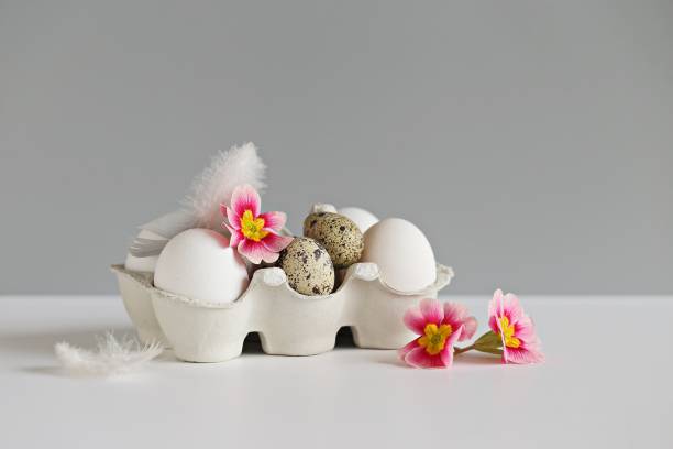 istock Chicken and quail eggs in eco-friendly packaging on light pastel background. 1365142213