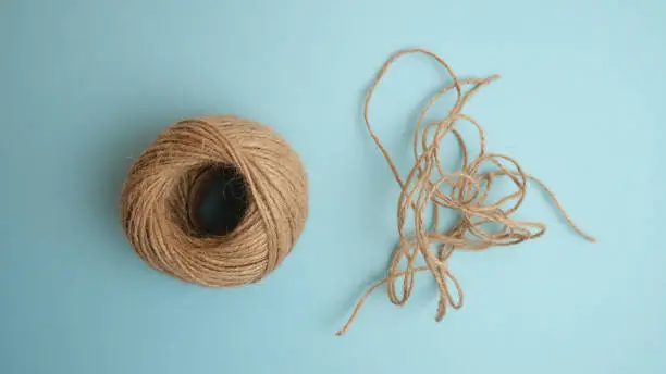 A ball of threads on a blue background. Thread cuttings. Contrast, difference.