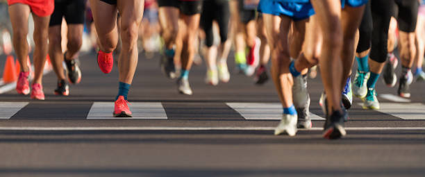 istock Marathon runners running on city road 1365144617