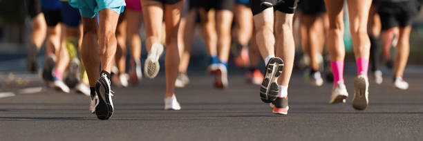 istock Marathon runners running on city road 1365145067