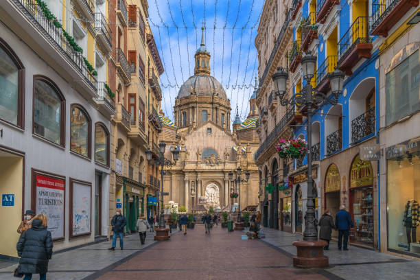 View of the Cathedral-Basilica of Our Lady of the Pillar from the Calle de Alfonso I pedestrian street in Zaragoza stock photo