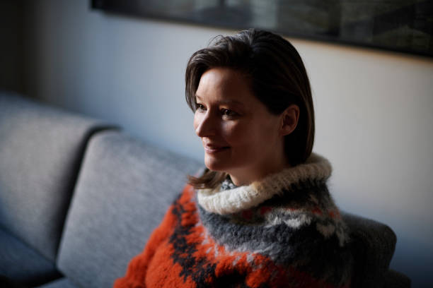 istock Mid adult woman in sofa 1365147505