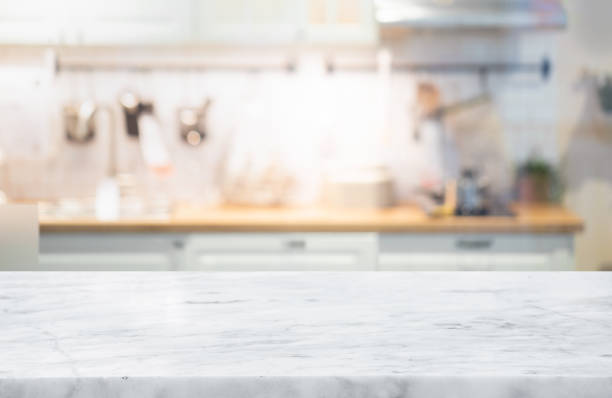 selective focus,marble table top on blur white kitchen room background. - aanrecht fotos stockfoto's en -beelden