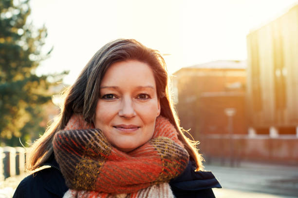istock Confident woman outdoors in backlit portrait 1365147881