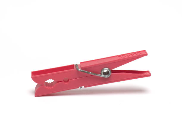istock red plastic clothespin metal spring white background 1365148703