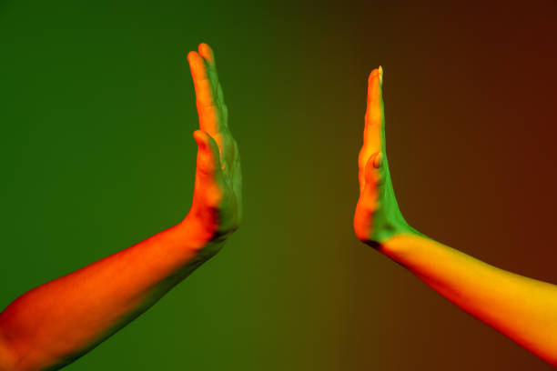 istock Two human hands gesturing isolated on green studio background in neon light. Concept of human relation, community, togetherness 1365149231