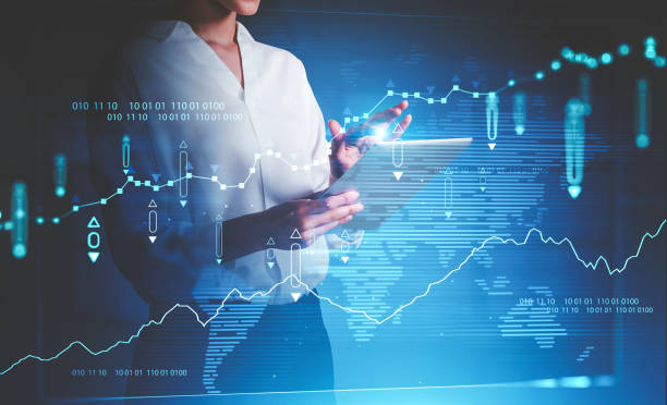 istock Woman with tablet computer and financial chart 1365150263