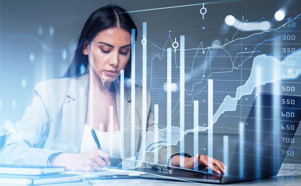 istock Businesswoman wearing formal suit working on laptop and taking notes 1365150422