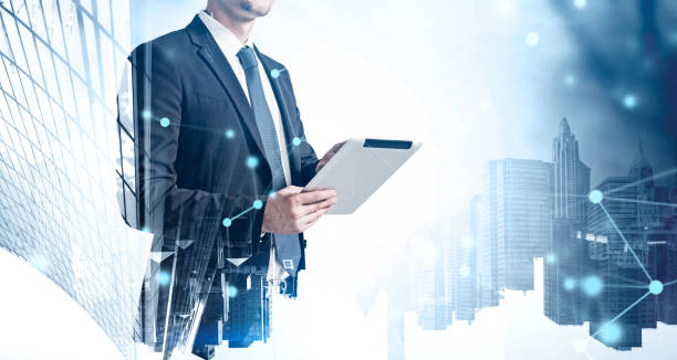 istock Businessman with tablet in city, graph 1365150726