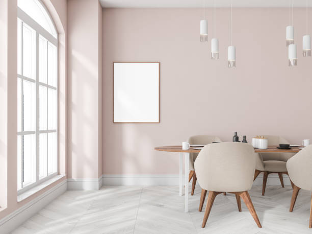 istock Pink dining room interior with table and chairs, window and mockup poster 1365154430