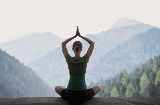 istock Woman is practicing yoga in a mountains. Meditation and harmony concept 1365155369