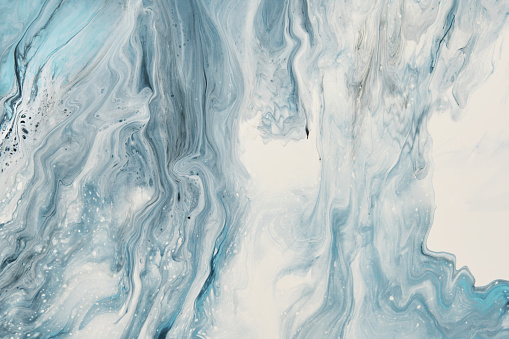 Arte fluido. La pintura abstracta blanca y azul líquida gotea y se agita. Fondo o textura de efecto mármol photo