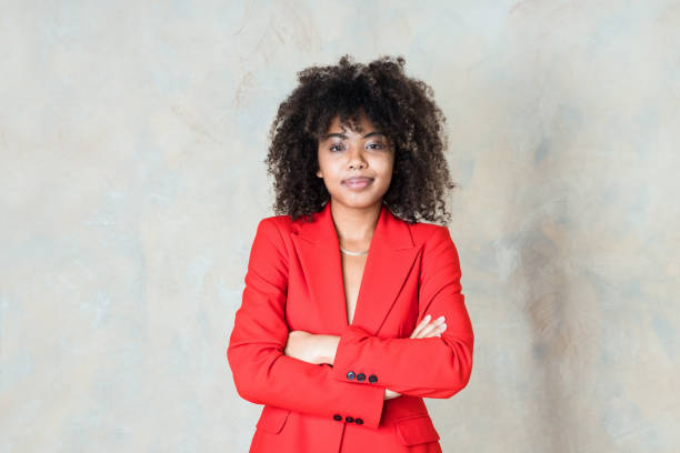 istock Friendly young woman wearing red blazer 1365157669