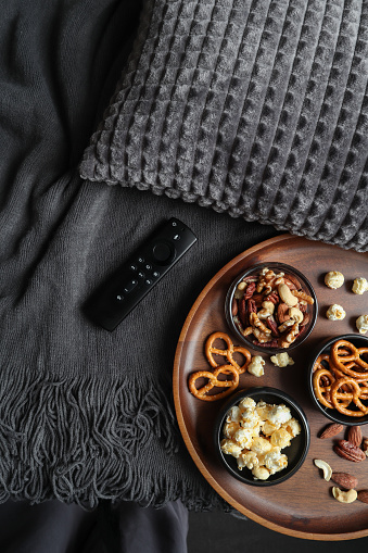 Netflix and chill sofa mood with smart tv remote and movie snacks