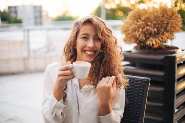 istock woman enjoying cappuccino in a cafe 1365157897