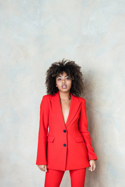 istock Young woman wearing red suit 1365157913