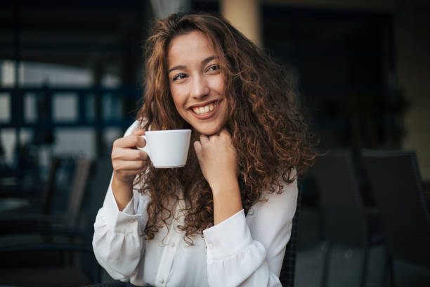 istock woman enjoying cappuccino in a cafe 1365157929