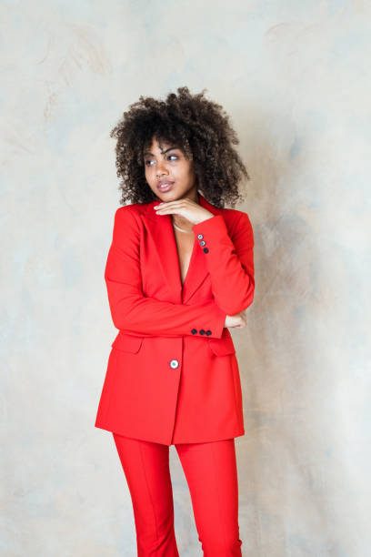 istock Young woman wearing red suit 1365158526