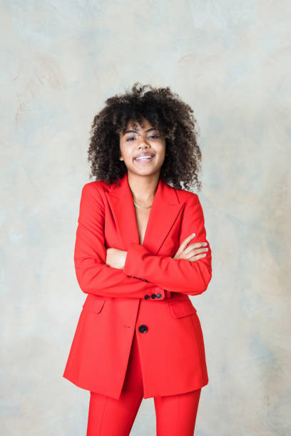 istock Young woman wearing red suit 1365158640