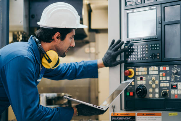 istock Male factory foreman using laptop repair on machine 1365158798