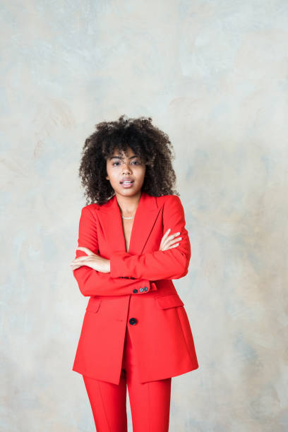 istock Young woman wearing red suit 1365158818