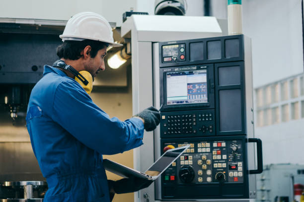 istock Male factory foreman using laptop repair on machine 1365158842