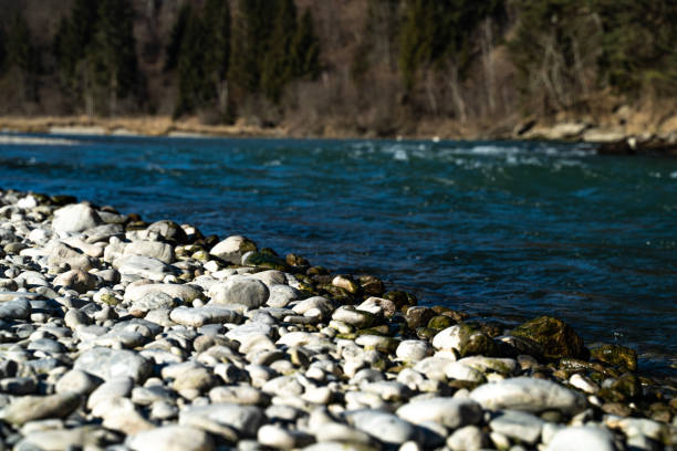 istock White rocks and stones at blue river 1365159245