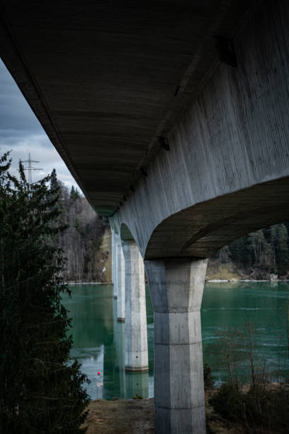 istock Bridge over turquoise water and overcast sky 1365159280
