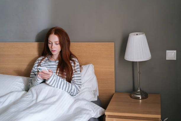 istock Front view of atractive young woman using mobile phone, looking on screen, typing online message on social media. 1365159337