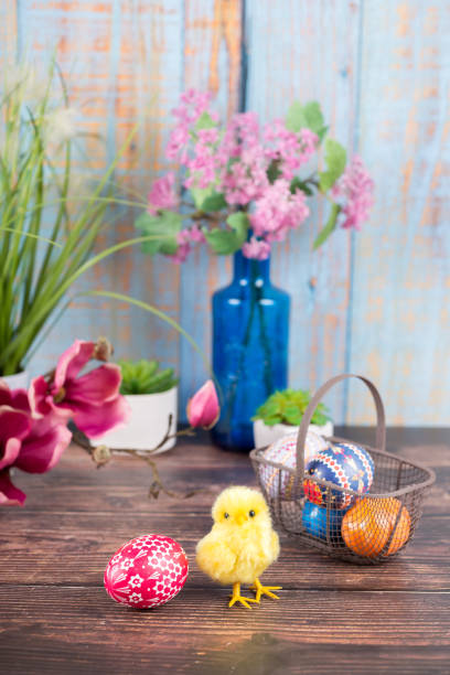 istock Easter. Basket with painted Easter eggs, magnolia and chicken 1365159507