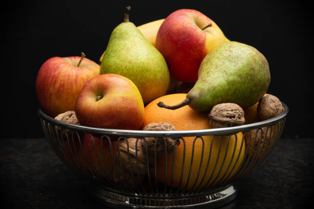 istock fruit basket with apples, pears, orange and nuts 1365159564