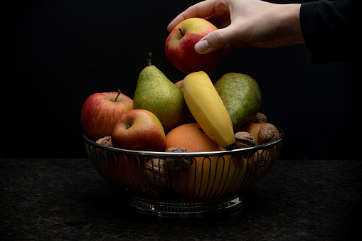 food, fruits, apple, banana, orange, pear, person, black background