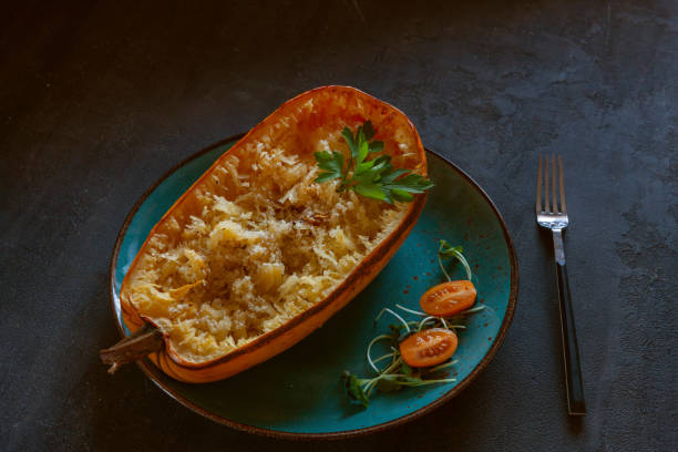 istock Fresh cooked organic spaghetti squash Cucurbita pepo vegetable on black background with grated cheese 1365160317