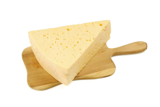 istock Triangular piece of cheese on cutting board, isolated on white background 1365165316