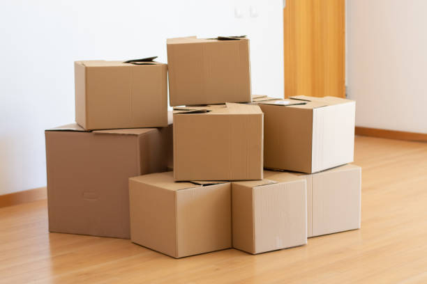 istock Pile of cardboard boxes in empty room 1365166446