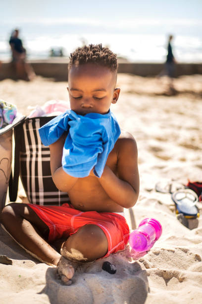 istock Adorable little boy playing on a sandy beach in summer 1365167243