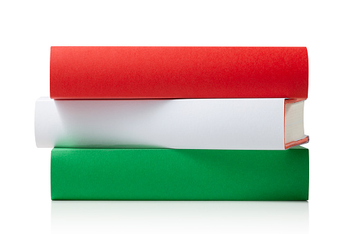 Books with the colors of the Italian flag isolated on white background.