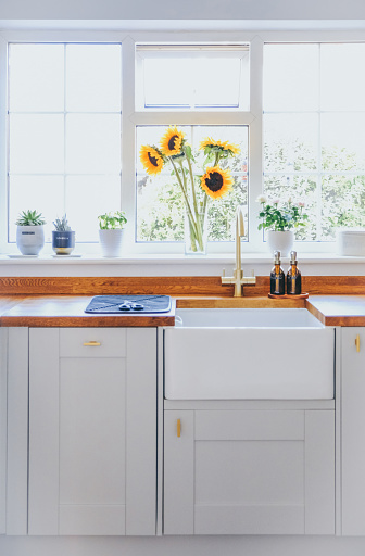 Modern and bright kitchen with wood worktop and hidden dishwasher