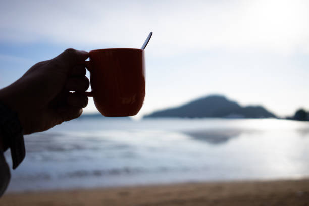 istock Coffee in a cup with the warm morning sea 1365172293