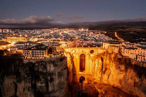 Drone aerial view of the city of Ronda with evening illumination