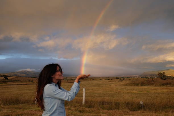 istock Girl catching a rainbow 1365173270