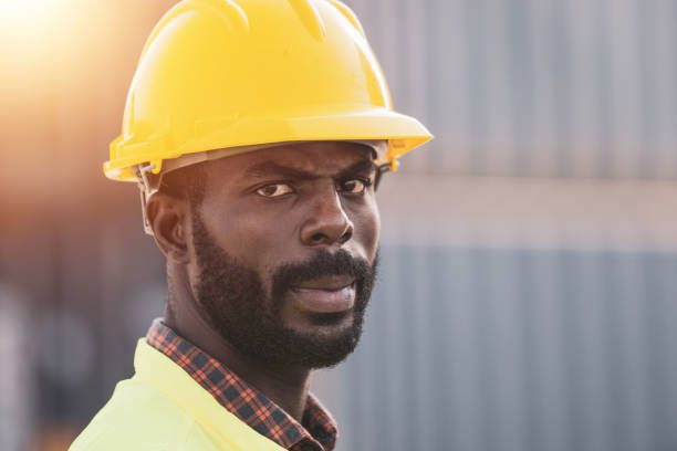 istock African American worker working in Import-export cargo yard, large-scale transportation via barges 1365173576