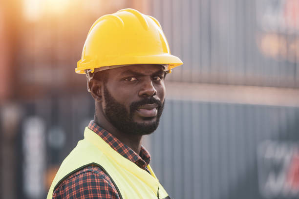 istock African American worker working in Import-export cargo yard, large-scale transportation via barges 1365173580