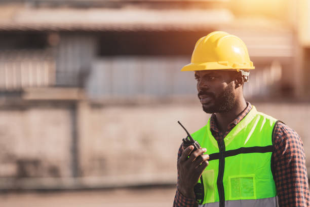 istock African American worker working in Import-export cargo yard, large-scale transportation via barges 1365173581