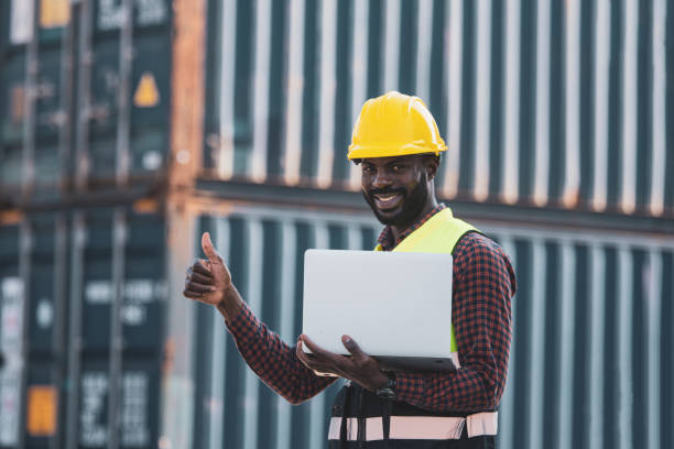 istock African american worker using laptop computer inspecting the containers. to manage the export of goods to foreign countries 1365173602