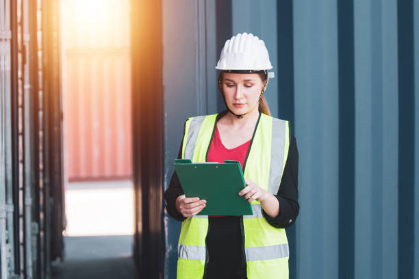 istock Businesswomen import export manager shipment large cargo sea transportation by cargo ships containers 1365173626